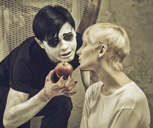 Mime teasing a woman with an apple